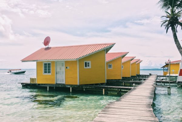 photo of brown houses on body of water
